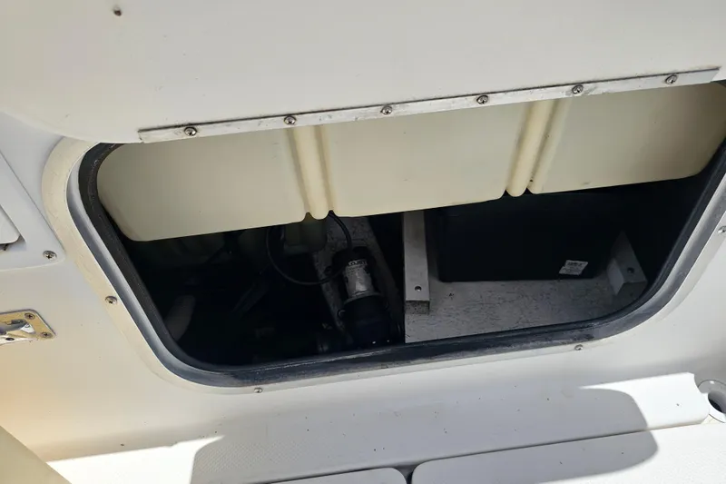 Slide: The Image of Open storage compartment on a 1998 Bayliner 2503 Trophy Center Console boat. - 15