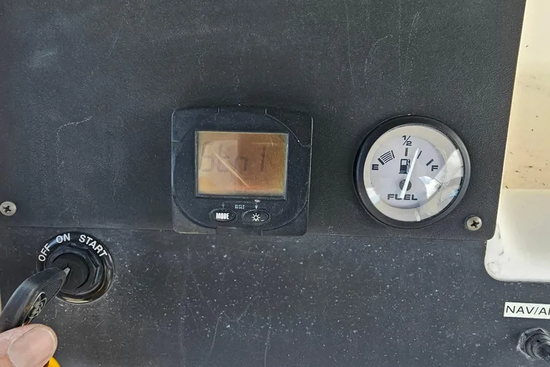 Slide: The Image of Dashboard of a 1998 Bayliner 2503 Trophy Center Console with fuel gauge and ignition switch. - 17
