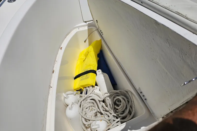 Slide: The Image of Storage compartment on 1998 Bayliner 2503 Trophy boat with life jacket and ropes. - 19