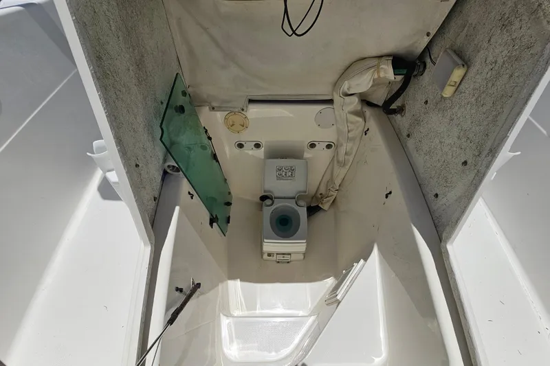 Slide: The Image of 1998 Bayliner 2503 Trophy Center Console boat interior with portable toilet. - 23