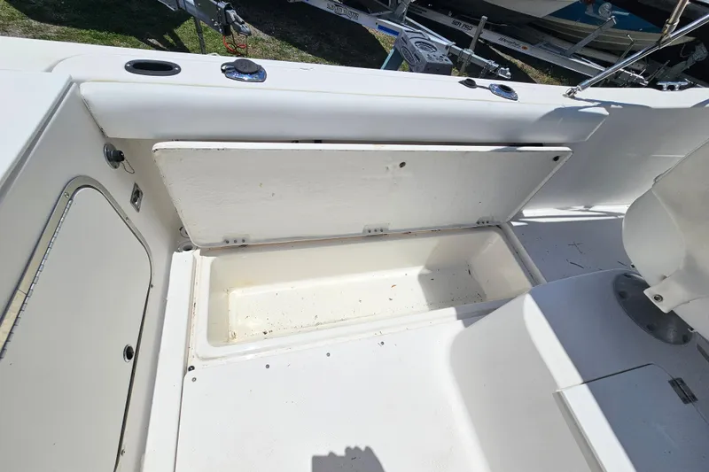 Slide: The Image of 1998 Bayliner 2503 Trophy Center Console boat with open storage compartment. - 25