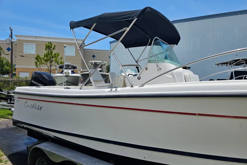 Slide: The Image of 1998 Bayliner 2503 Trophy Center Console boat with canopy, parked on a trailer. - 8