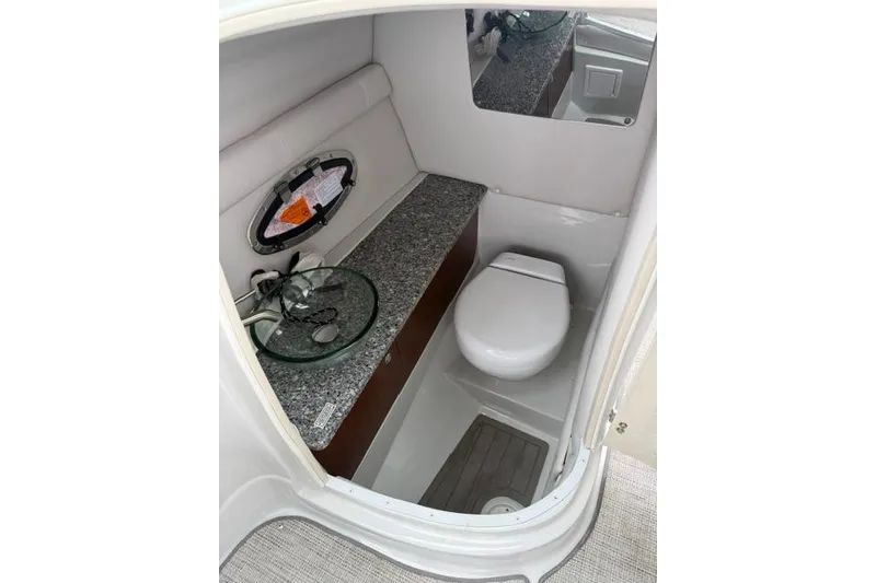 Slide: The Image of 2022 Crownline 265 SS boat bathroom with modern fixtures and granite countertop. - 10