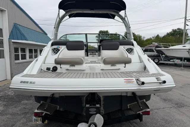 Slide: The Image of 2022 Crownline 265 SS boat with spacious deck and seating, docked at a marina. - 15