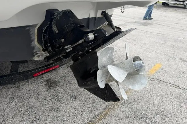 Slide: The Image of 2022 Crownline 265 SS boat propeller and stern drive on pavement. - 19