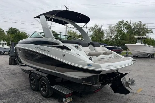Slide: The Image of 2022 Crownline 265 SS boat on trailer, featuring sleek design and spacious seating. - 4