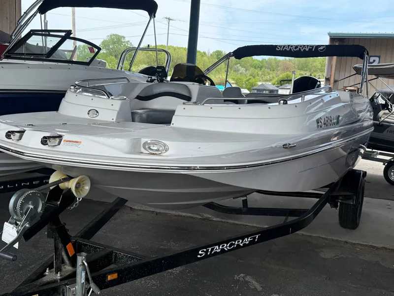 The Image of 2015 Starcraft 2000 IO Limited boat on trailer outdoors. - 0