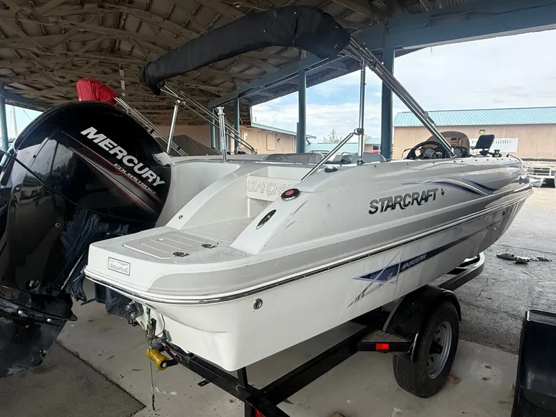 Slide: The Image of Starcraft 2000 IO Limited 2015 boat with Mercury outboard motor. - 2