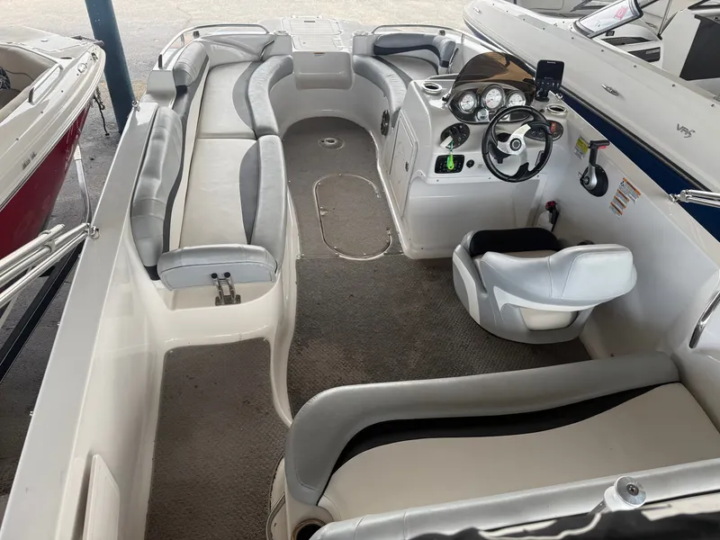 Slide: The Image of Interior view of a 2015 Starcraft 2000 IO Limited boat with gray seating. - 6