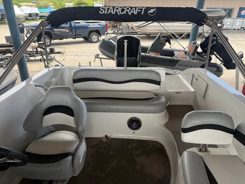 Slide: The Image of Interior of a 2015 Starcraft 2000 IO Limited boat with gray seating. - 9