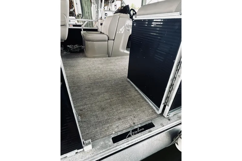 Slide: The Image of 2021 Avalon LSZ Rear Fish 22' boat interior with seating and carpeted floor. - 13