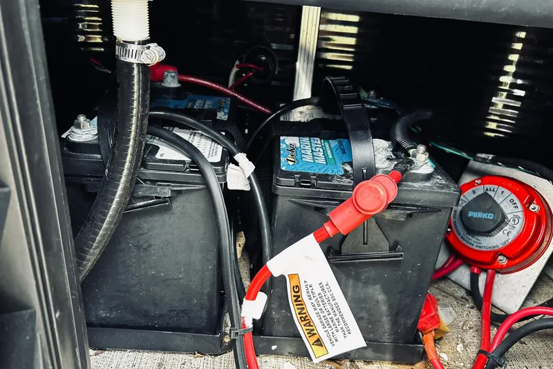 Slide: The Image of Battery compartment of 2021 Avalon LSZ Rear Fish boat with wiring and switch. - 17