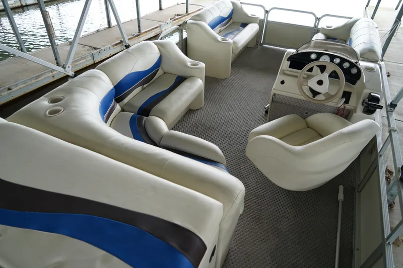 Slide: The Image of Interior of a 2005 Bennington II 207L pontoon boat with plush seating and steering console. - 3