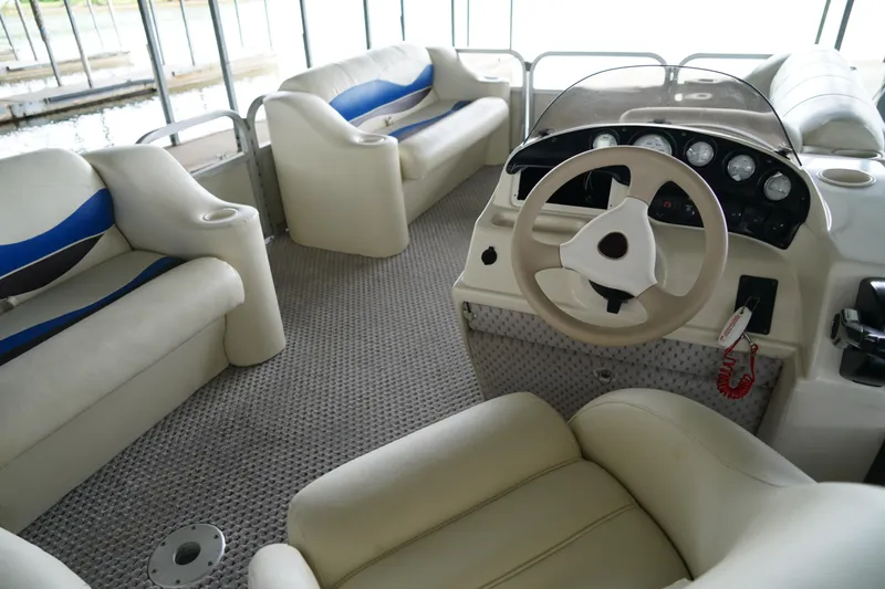 Slide: The Image of Interior of a 2005 Bennington II 207L pontoon boat with plush seating and steering console. - 4