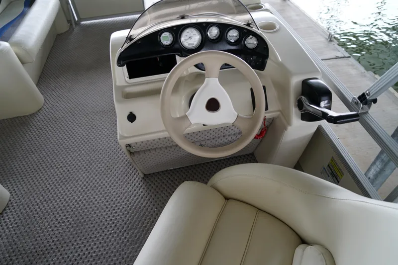 Slide: The Image of Steering console of a 2005 Bennington II 207L boat with beige interior. - 5
