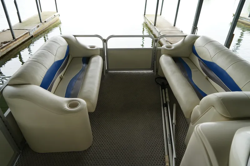 Slide: The Image of Interior of a 2005 Bennington II 207L pontoon boat with cushioned seating. - 6