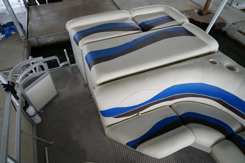 Slide: The Image of 2005 Bennington II 207L boat interior with blue and black striped seating. - 9