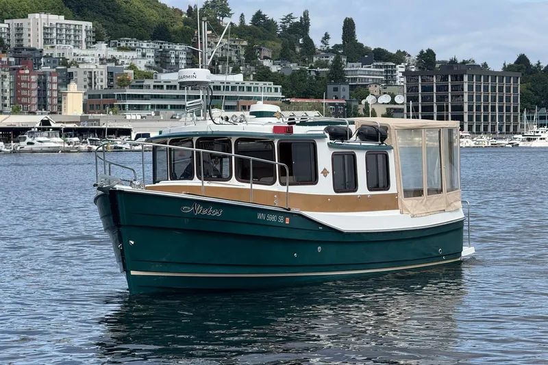 Slide: The Image of 2014 Ranger Tugs R-27 boat on water with cityscape background. - 10