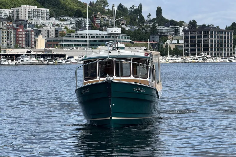 Slide: The Image of 2014 Ranger Tugs R-27 boat cruising in urban waterfront setting. - 11