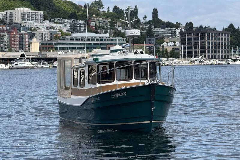 Slide: The Image of 2014 Ranger Tugs R-27 boat on water with urban backdrop. - 12
