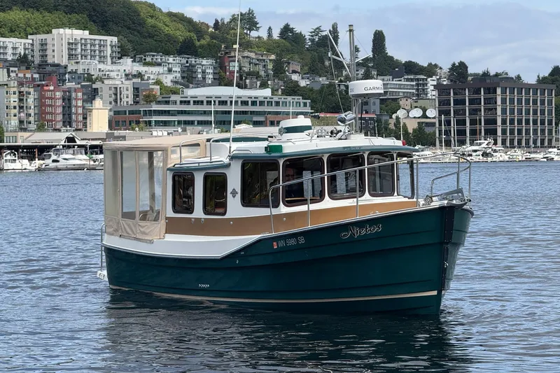 Slide: The Image of 2014 Ranger Tugs R-27 boat on water with cityscape background. - 13