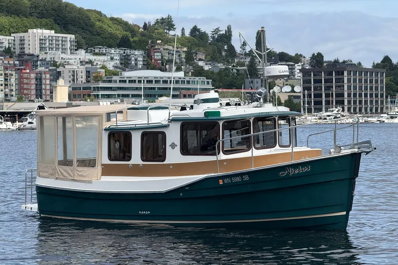Slide: The Image of 2014 Ranger Tugs R-27 boat docked in urban marina setting. - 14