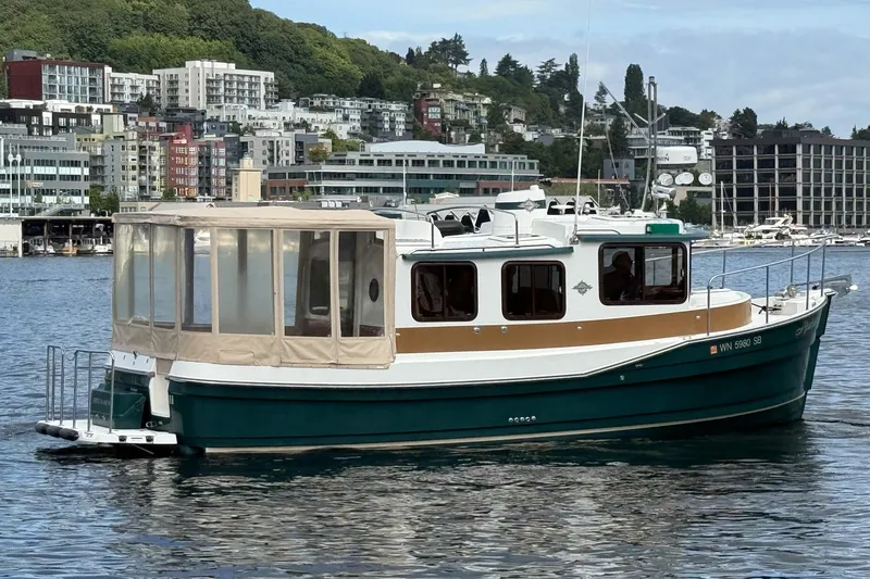 Slide: The Image of 2014 Ranger Tugs R-27 boat on water with cityscape background. - 19