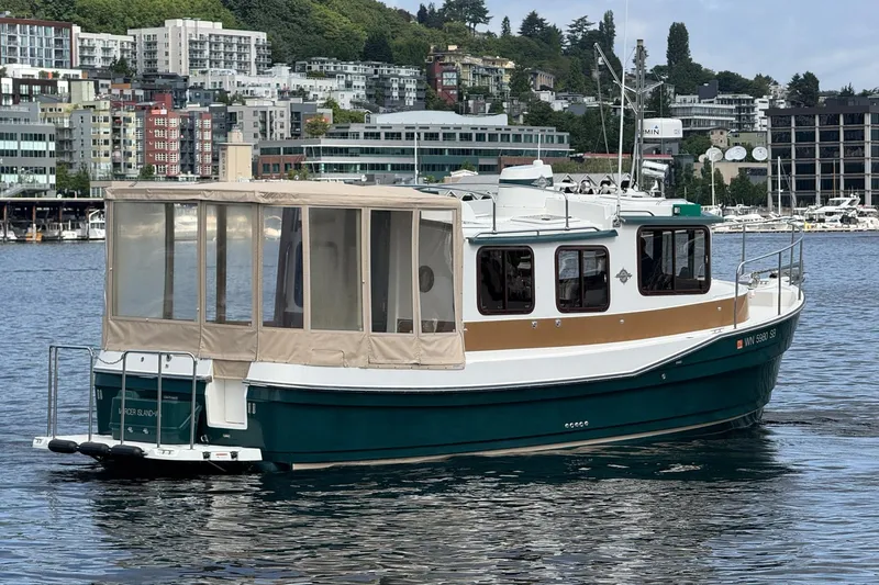 Slide: The Image of 2014 Ranger Tugs R-27 boat on water with cityscape background. - 20