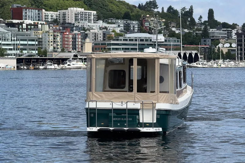Slide: The Image of 2014 Ranger Tugs R-27 boat on water with cityscape background. - 22