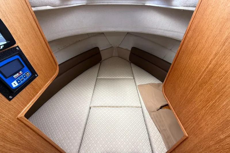 Slide: The Image of Interior cabin of 2014 Ranger Tugs R-27 boat with cushioned seating. - 30