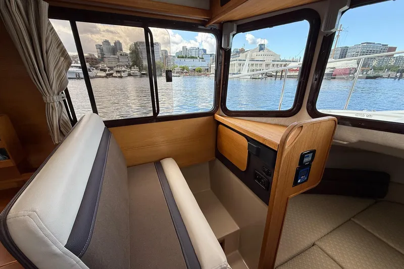 Slide: The Image of Interior view of 2014 Ranger Tugs R-27 boat with cityscape through windows. - 32