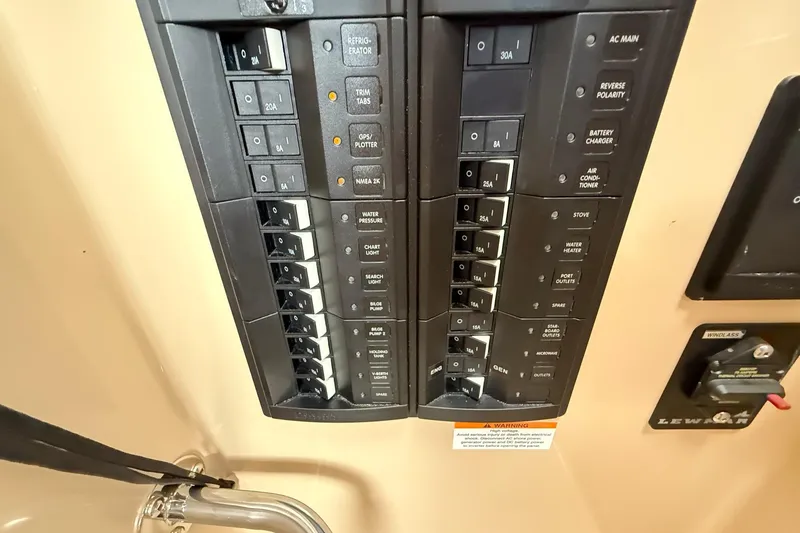 Slide: The Image of Electrical panel of a 2014 Ranger Tugs R-27 boat with labeled switches and controls. - 35