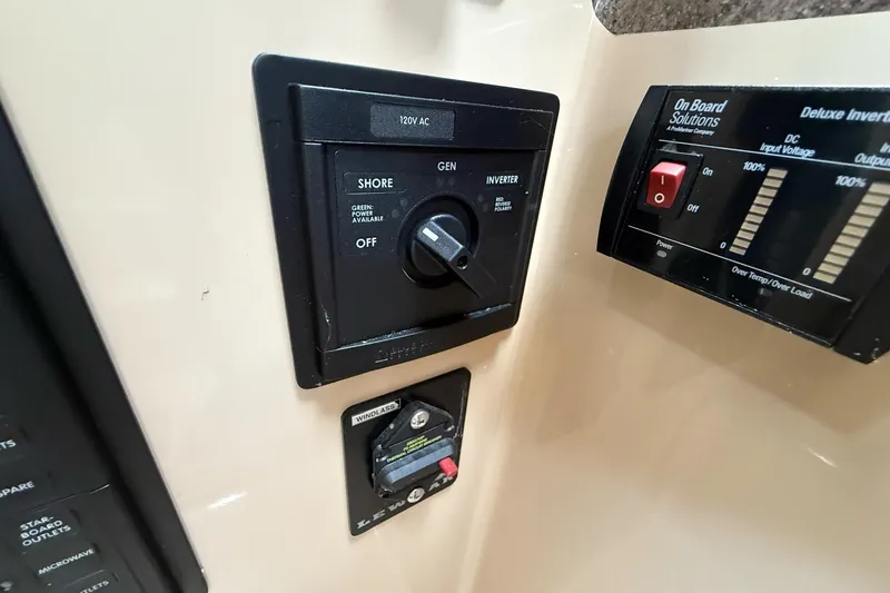 Slide: The Image of Control panel of a 2014 Ranger Tugs R-27 boat, featuring power and inverter switches. - 36