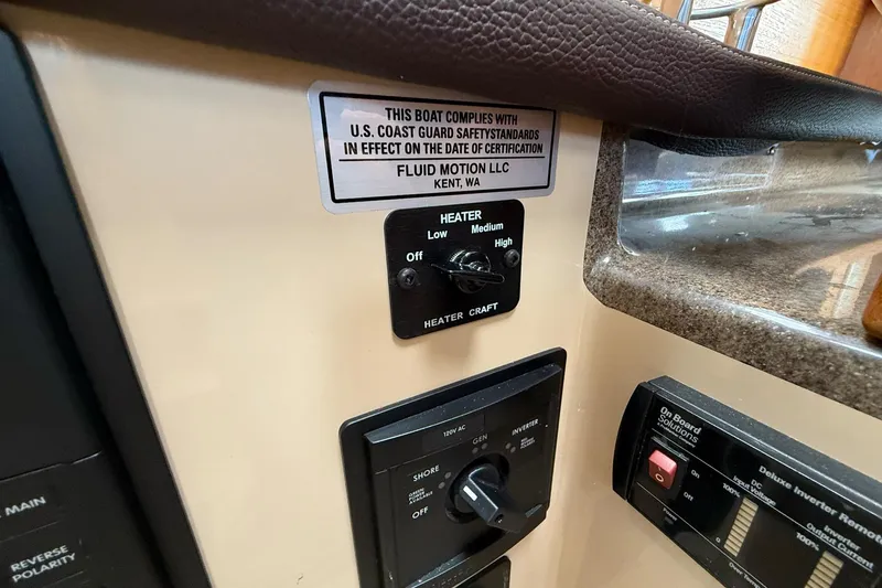 Slide: The Image of Control panel of a 2014 Ranger Tugs R-27 boat with safety compliance label. - 37