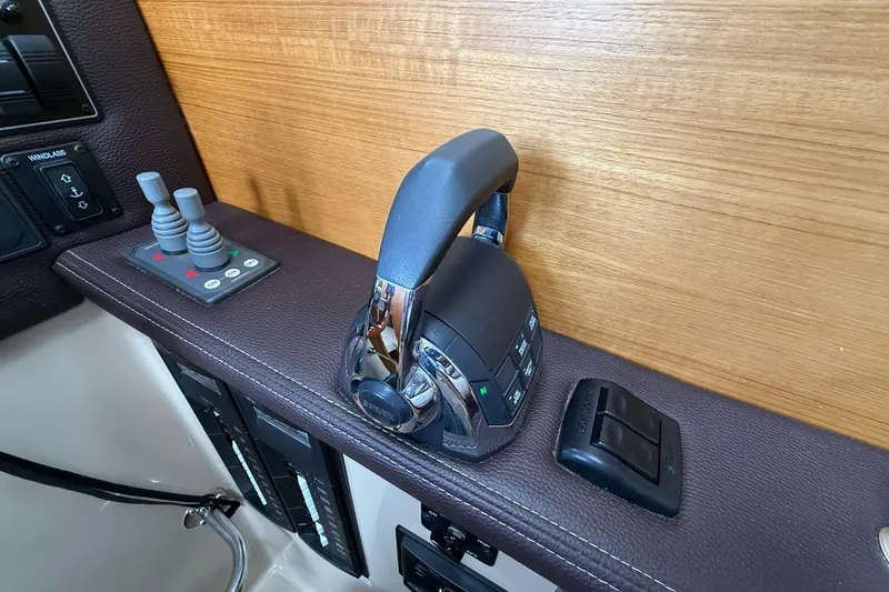Slide: The Image of Control panel of a 2014 Ranger Tugs R-27 boat with throttle and switches. - 38