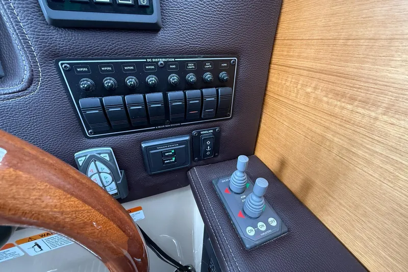Slide: The Image of Control panel of a 2014 Ranger Tugs R-27 boat with switches and joysticks. - 39