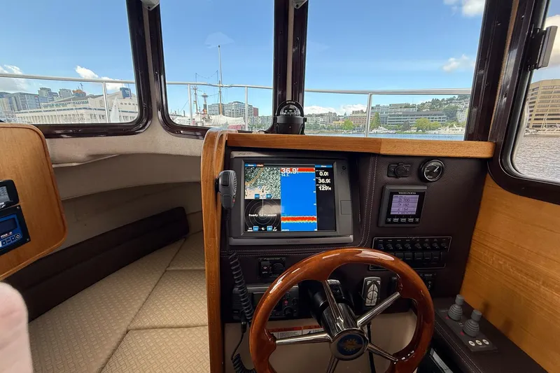 Slide: The Image of Interior view of 2014 Ranger Tugs R-27 helm with navigation equipment and steering wheel. - 43
