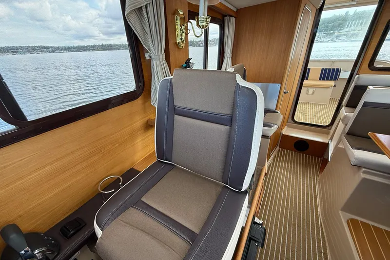 Slide: The Image of Interior of a 2014 Ranger Tugs R-27 boat with seating and scenic water view. - 44