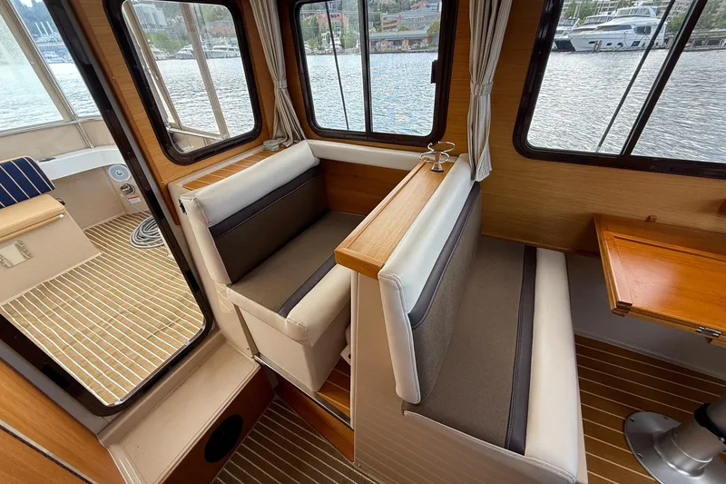 Slide: The Image of Interior of 2014 Ranger Tugs R-27 boat with seating and wood accents. - 53