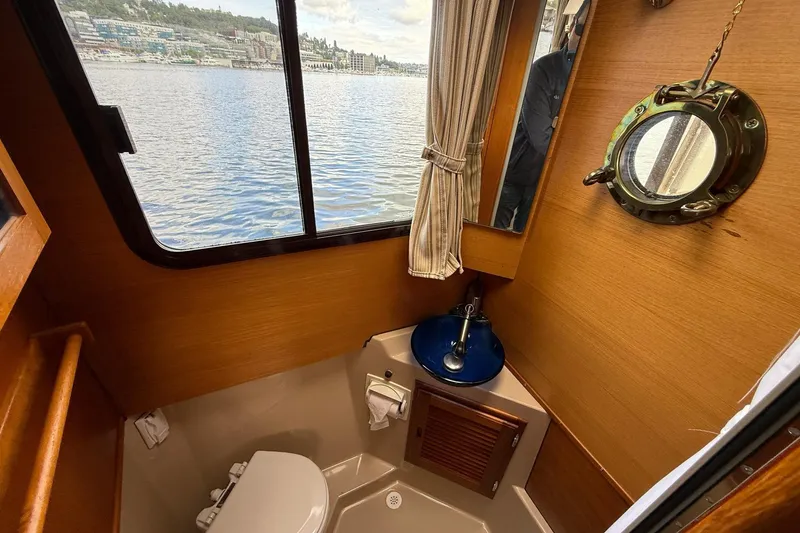 Slide: The Image of 2014 Ranger Tugs R-27 boat bathroom with window view and nautical decor. - 56