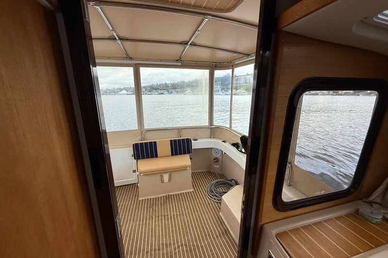 Slide: The Image of Interior view of 2014 Ranger Tugs R-27 boat with lake scenery. - 57