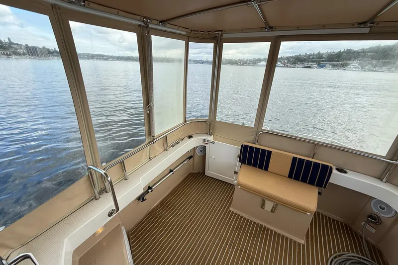 Slide: The Image of 2014 Ranger Tugs R-27 boat interior with panoramic lake view. - 59