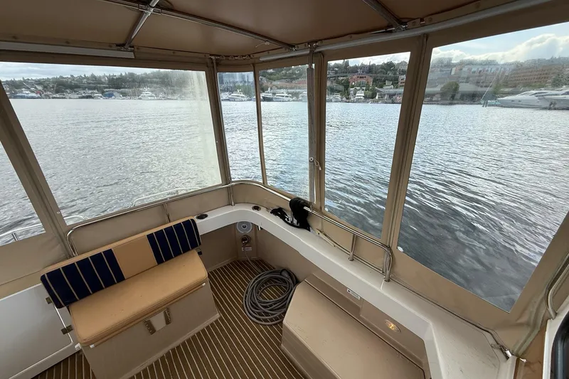 Slide: The Image of 2014 Ranger Tugs R-27 boat interior with lake view through windows. - 60