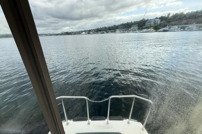 Slide: The Image of View from 2014 Ranger Tugs R-27 boat, overlooking calm waters and distant shoreline. - 61