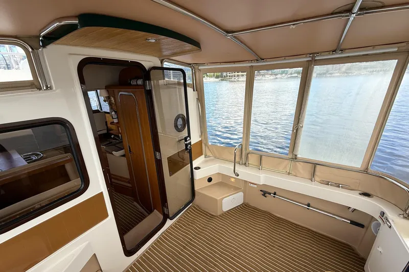 Slide: The Image of 2014 Ranger Tugs R-27 boat interior with spacious cabin and lake view. - 63