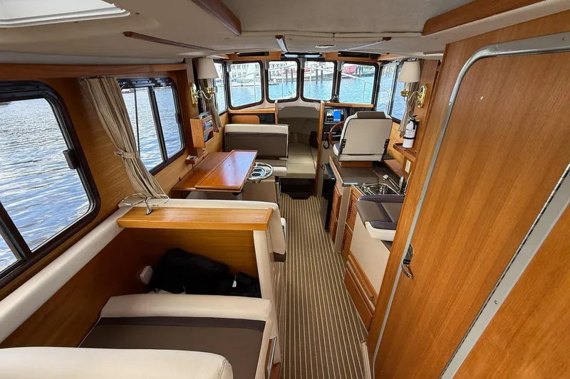 Slide: The Image of Interior of 2014 Ranger Tugs R-27 boat with wood finishes and seating area. - 65