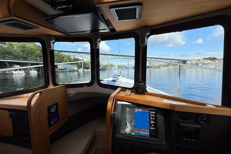 Slide: The Image of Interior view of 2014 Ranger Tugs R-27 boat with navigation system and scenic waterway. - 66