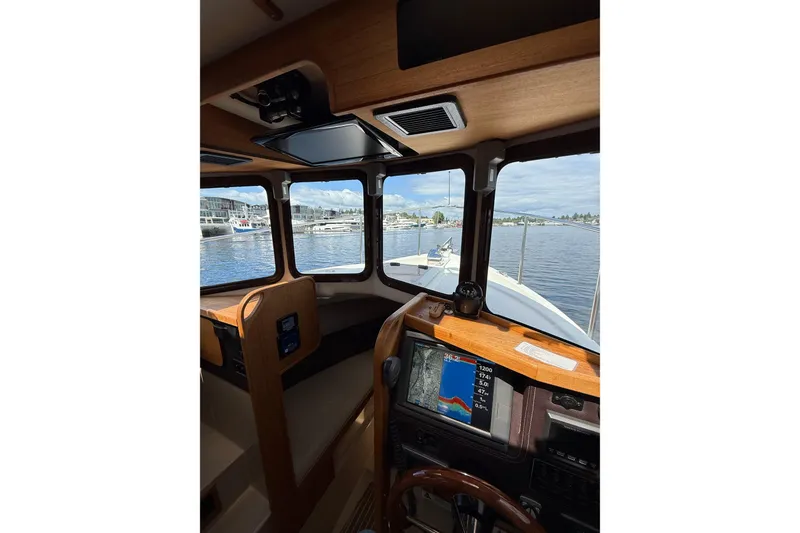 Slide: The Image of Interior view of 2014 Ranger Tugs R-27 boat cockpit with navigation display. - 67