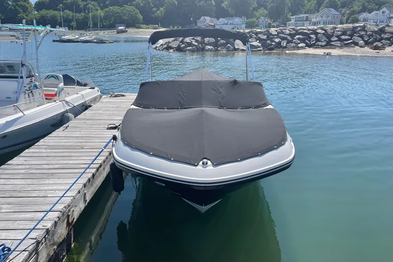 Slide: The Image of 2019 Bayliner VR5 Bowrider I/O docked with cover on, calm waters. - 21