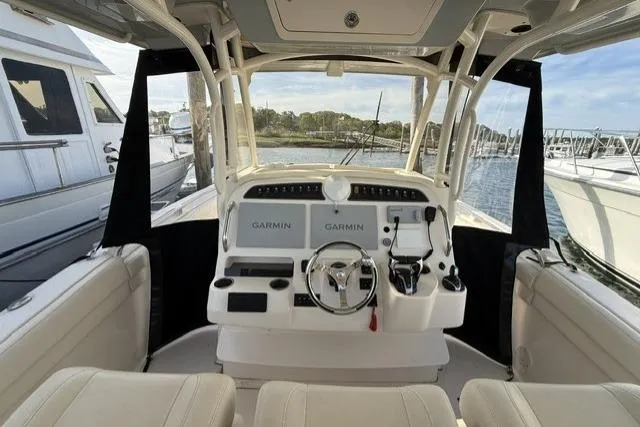 Slide: The Image of 2023 Grady-White Canyon 326 boat interior with Garmin navigation system, docked at marina. - 10